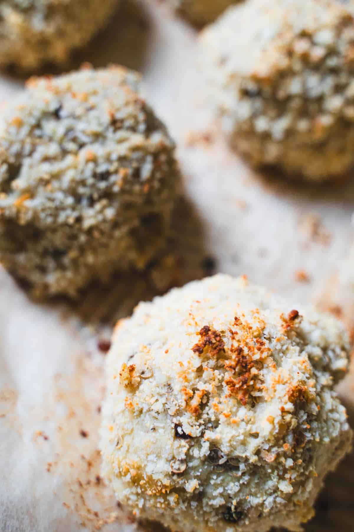 Baked Asian eggplant meatballs on parchment paper.