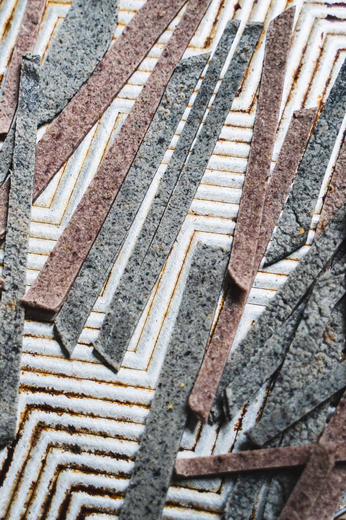 Tortilla strips on a baking sheet ready to be baked for a crispy and golden brown finish.
