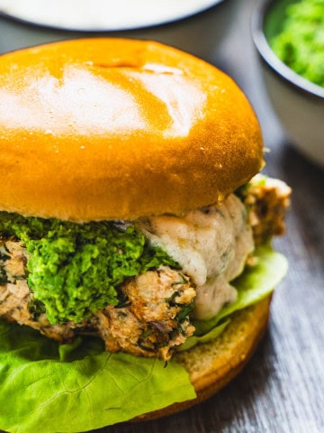 Salmon slider on a brioche bun with mint pea puree and white champagne sauce.