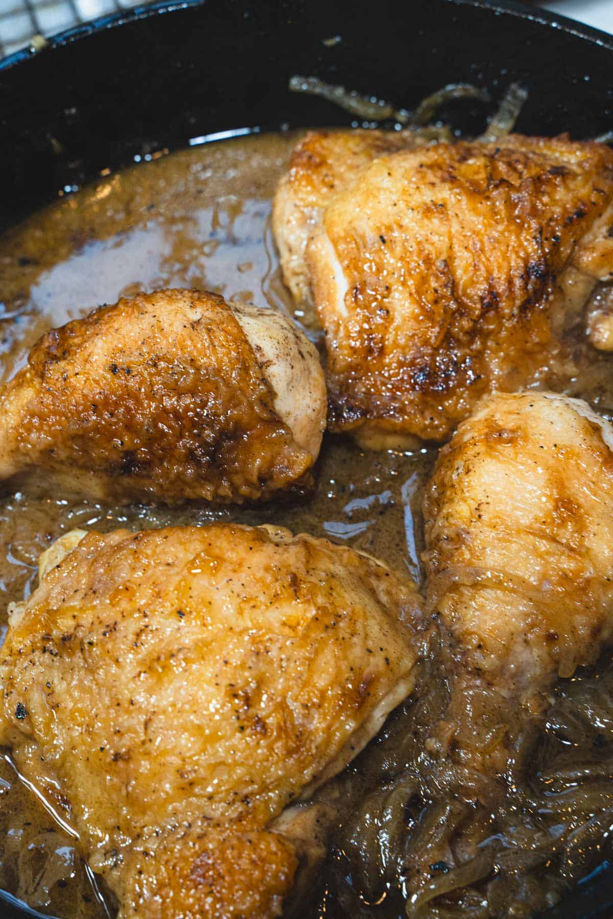 Chicken thighs and legs braising in apple cider for Chicken Normandy.