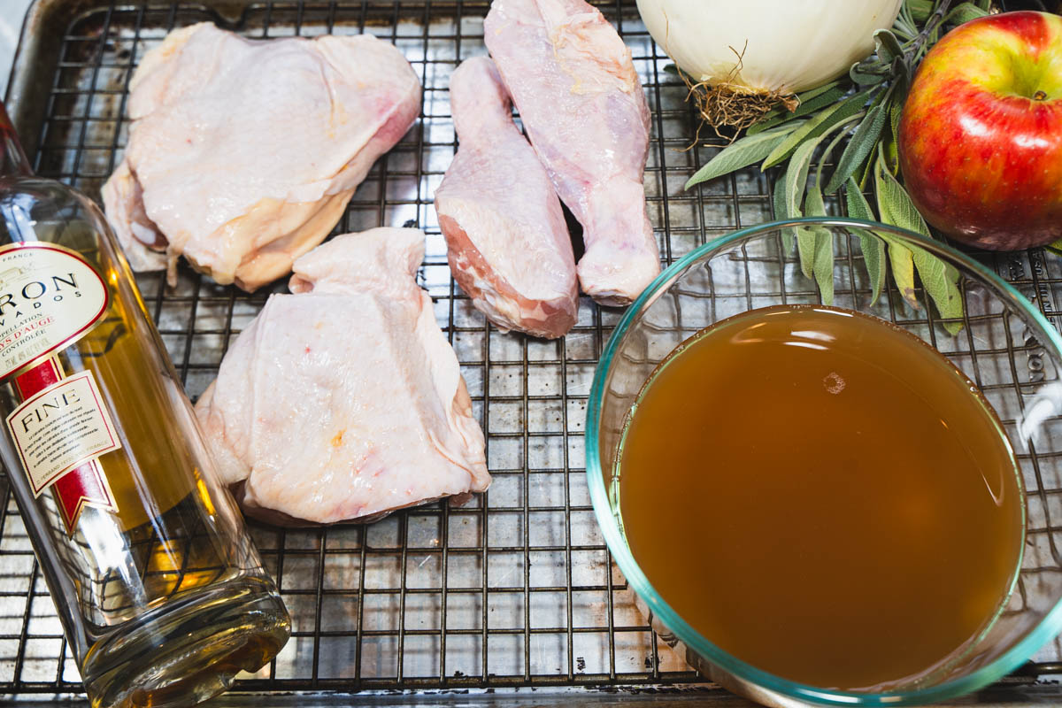 Braised chicken ingredients on a wire rack inserted into a baking sheet.