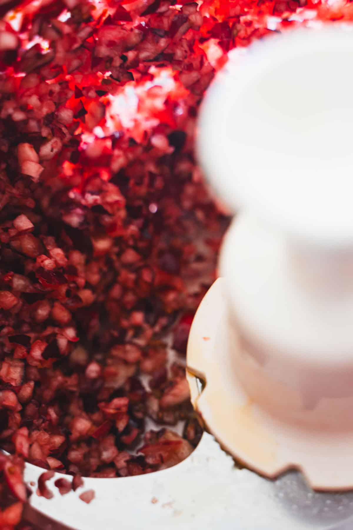 Finely chopped cranberries in a food processor bowl.