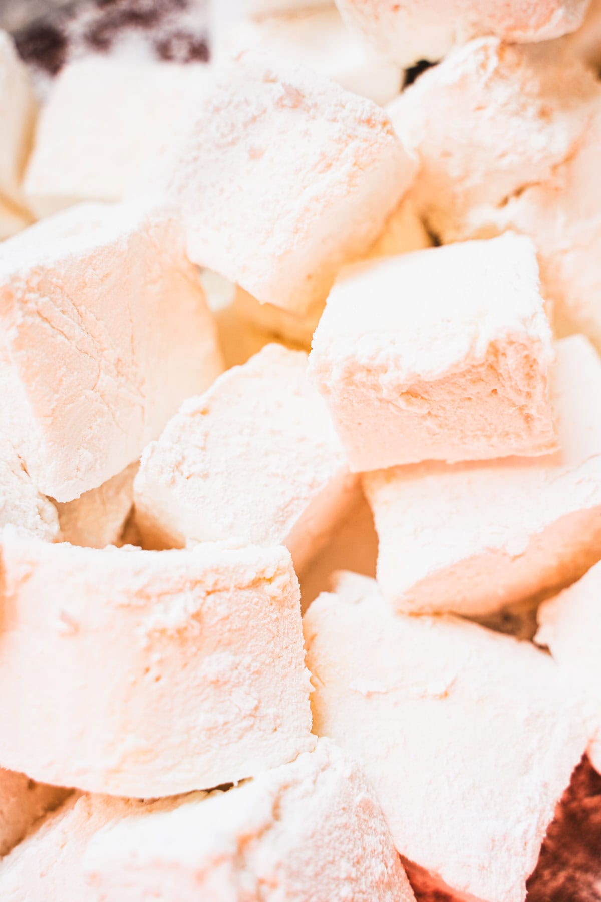 Homemade marshmallows cut into cubes dusted in confectioners' sugar.