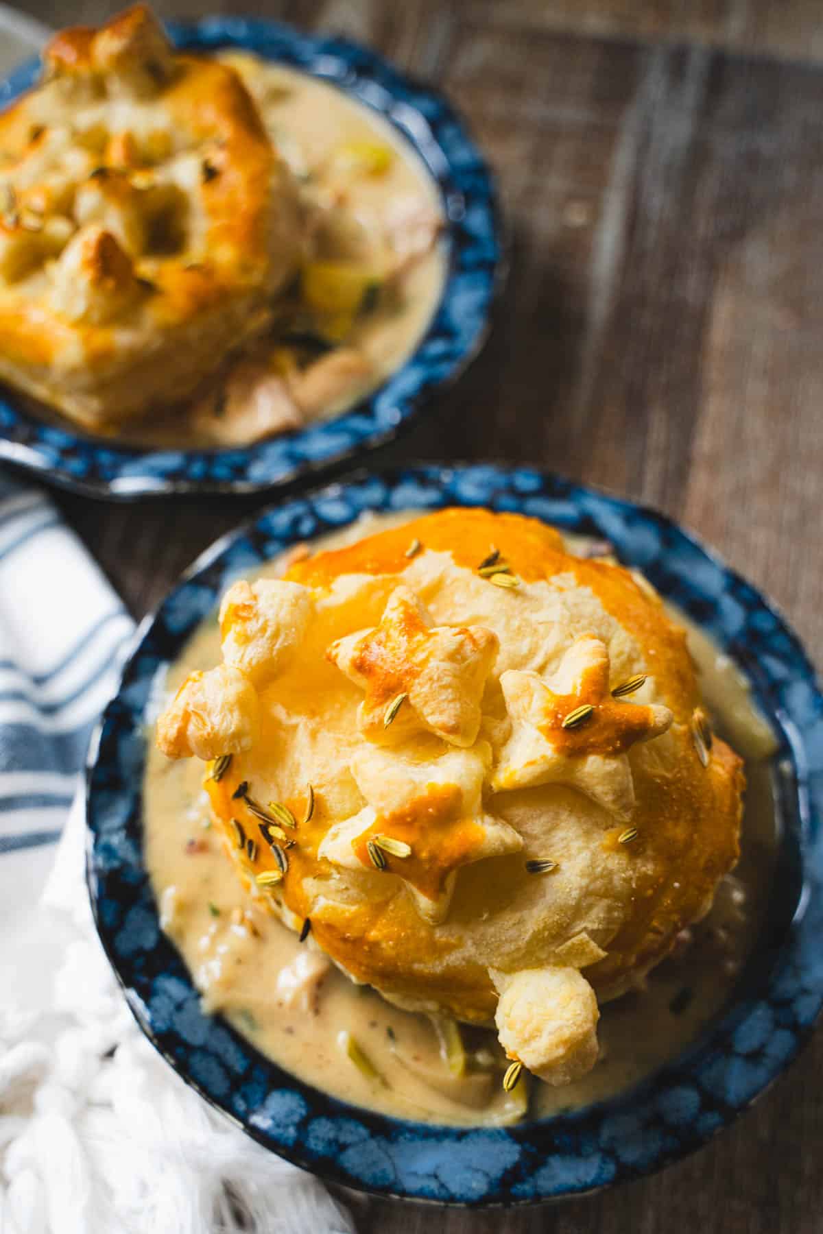Puff Pastry chicken pot pie in a individual blue pie plate.