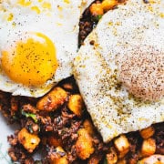 Spanish Eggs with plant based chorizo and eggs on a white platter.