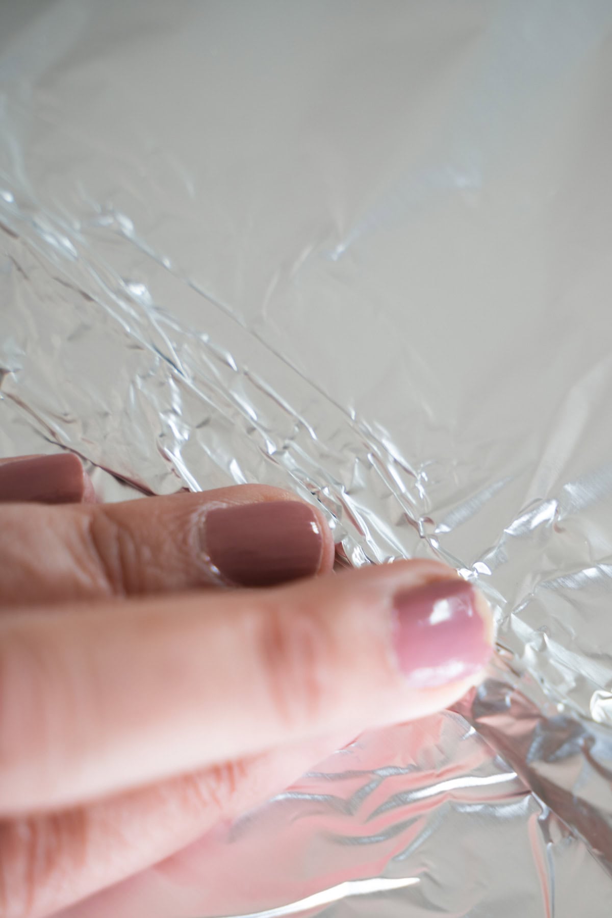 creating a seam to attach two foil sheets together to bake sticky ribs in oven.