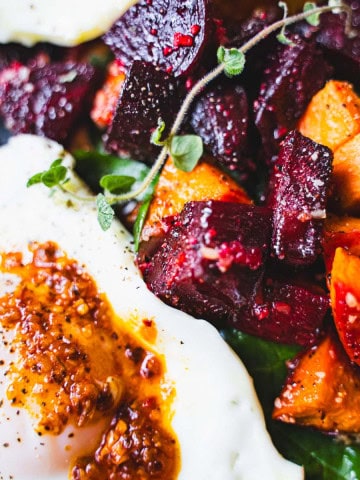 Sheet pan roasted beets and sweet potato breakfast hash with eggs.