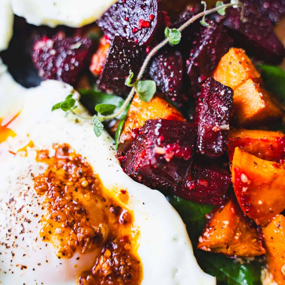 Sheet pan roasted beets and sweet potato breakfast hash with eggs.