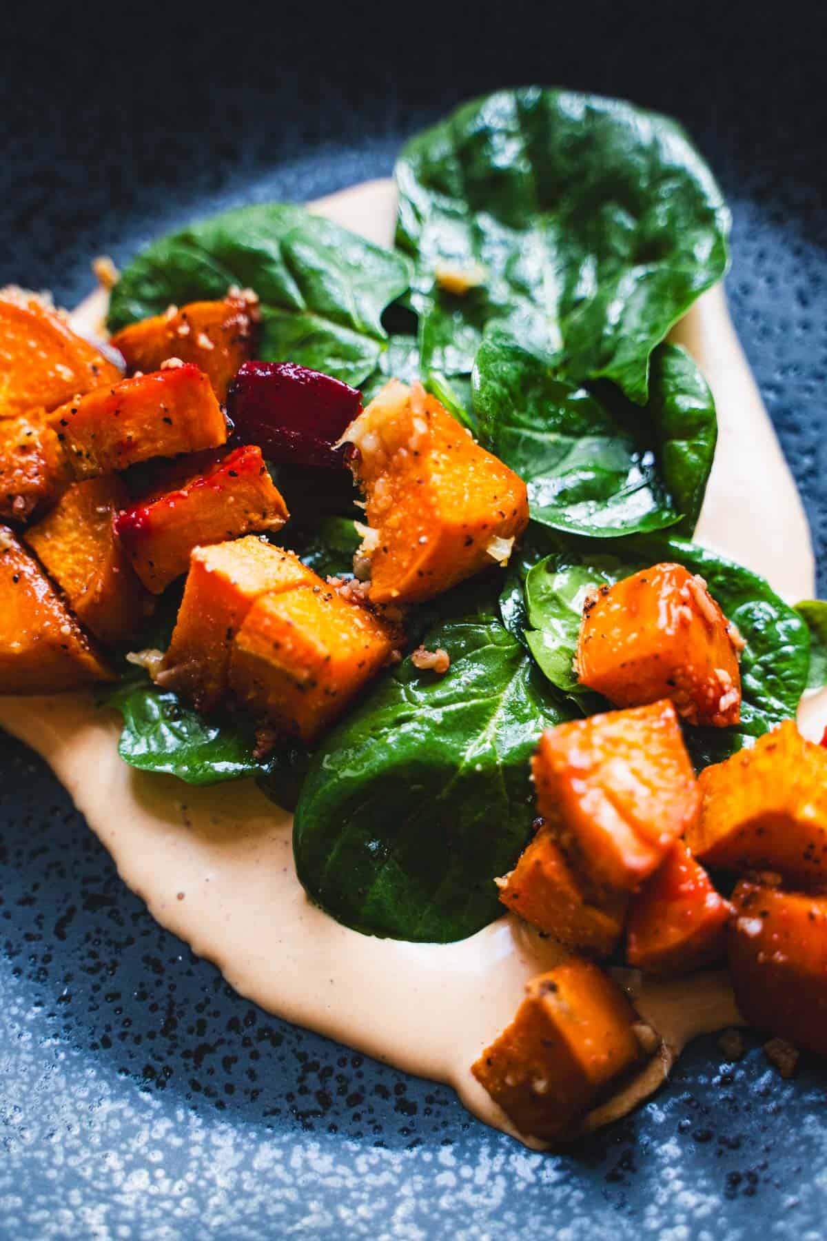 Roasted vegetables on spinach salad and chipotle mayo to make breakfast hash.
