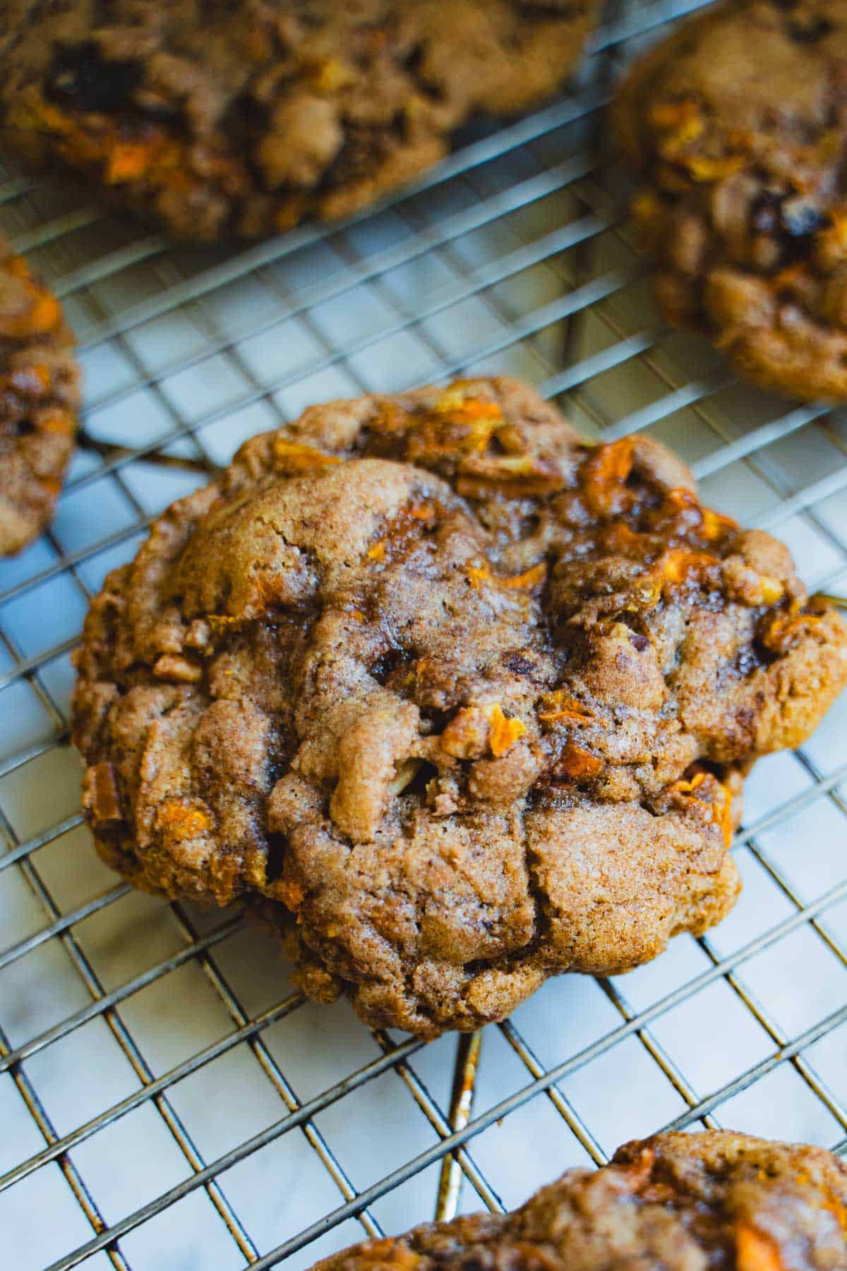 Baked carrot cake cookies on wire cooling rack.