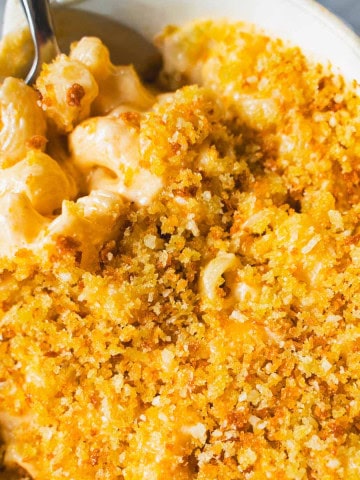 Grown up version of 3 cheese mac and cheese on a spoon in a ramekin.