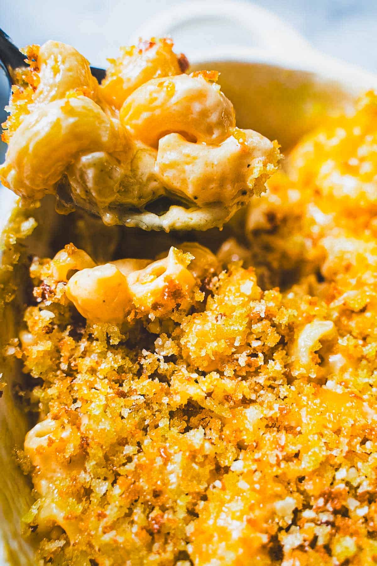 Grown up version of 3 cheese mac and cheese on a spoon in a ramekin.