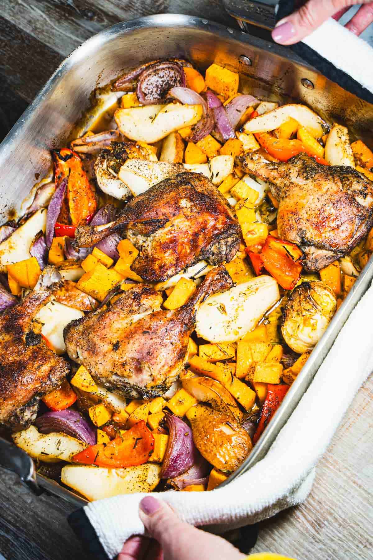 Duck leg Confit Weeknight dinner for two with sweet potatoes, red pepper, pears and roasted garlic in a sheet pan.