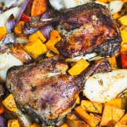 Duck leg Confit Weeknight dinner for two with sweet potatoes, red pepper, pears and roasted garlic in a sheet pan.