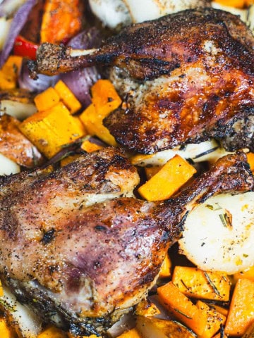 Duck leg Confit Weeknight dinner for two with sweet potatoes, red pepper, pears and roasted garlic in a sheet pan.