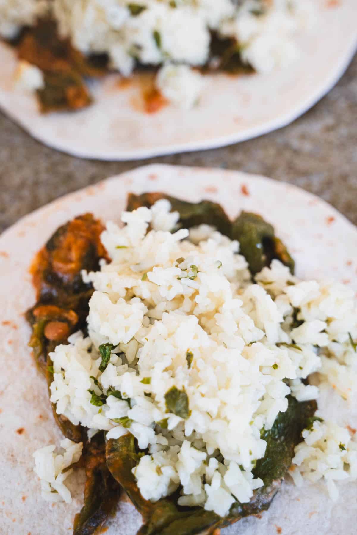 Chile relleno, pinto beans and rice filling on tortilla.