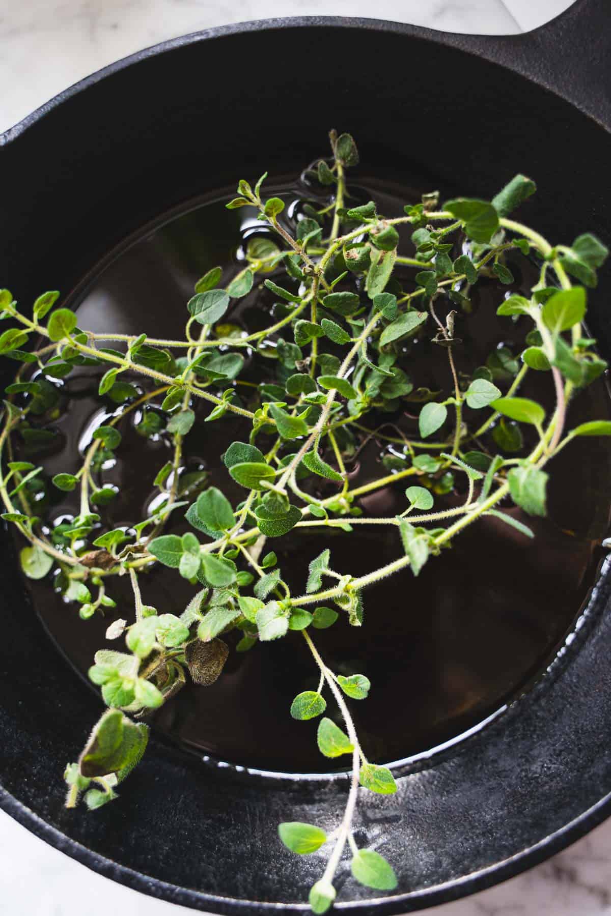 oregano sprigs in a cast iron skillet.