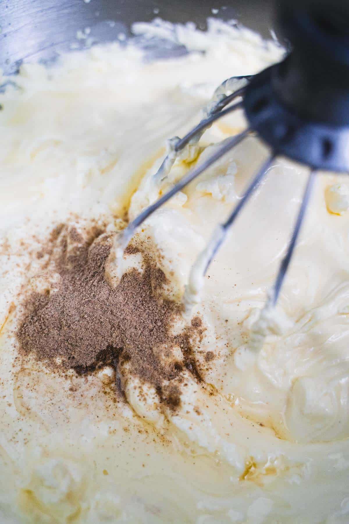 Cardamom and rose water added to whipped cream in stand mixer to make Kulfi no churn ice cream bars.