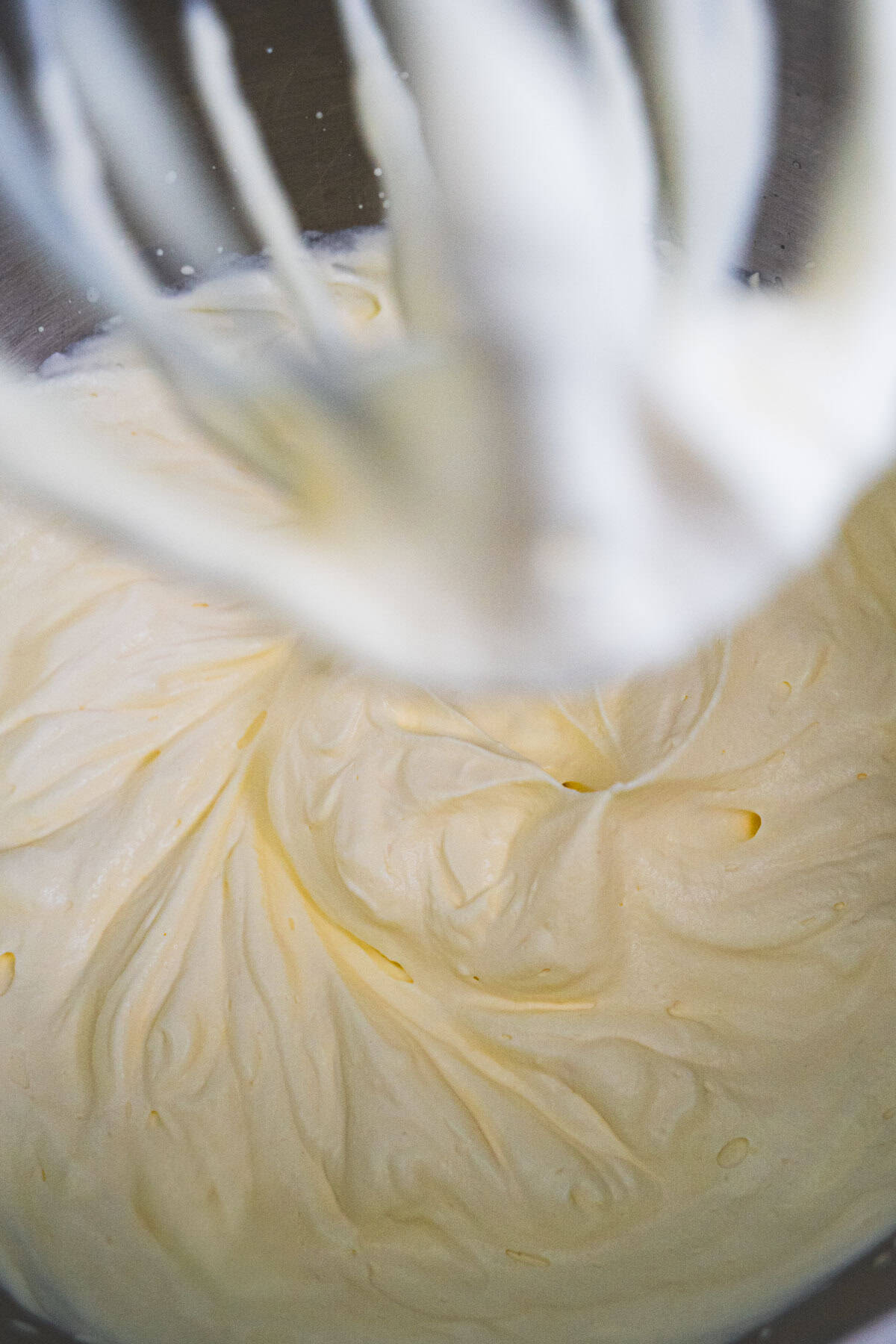 Whipped saffron-cream mixture in stand mixer into soft peaks for Kulfi.