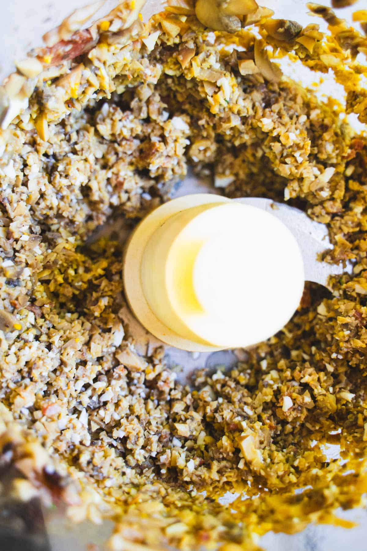 Finely chopped mushrooms, egg and bacon in food processor bowl for Mushroom Salad.