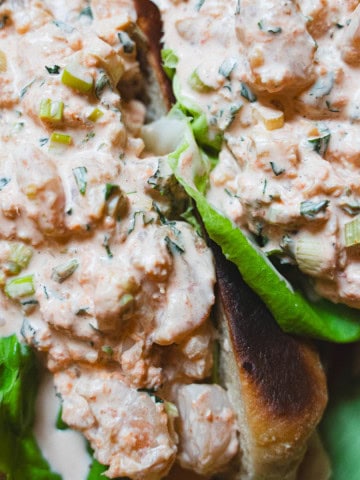 Two asian style shrimp rolls on a green platter.