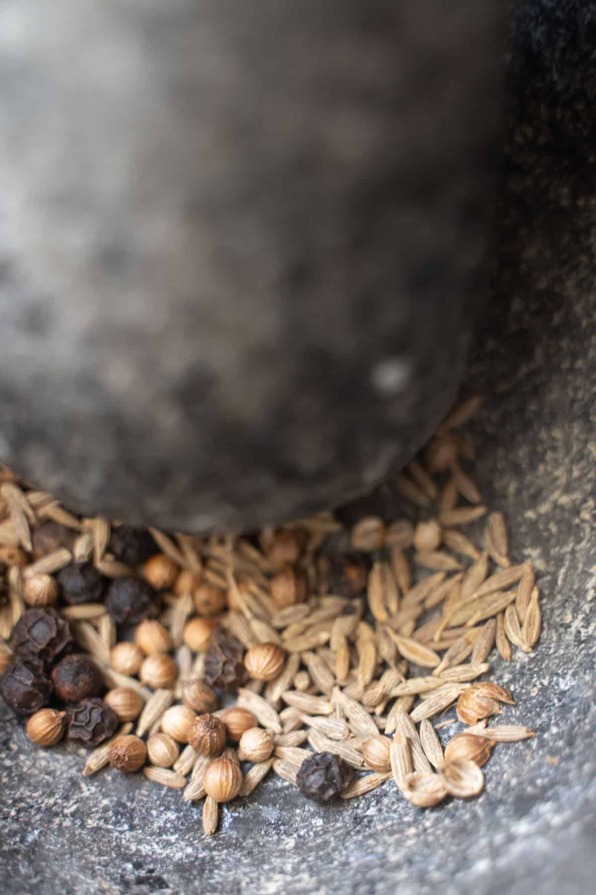 Spices for mushroom salad in mortar and pestle.