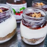 Cherry topping added to the no bake cheesecake in a mason jar.
