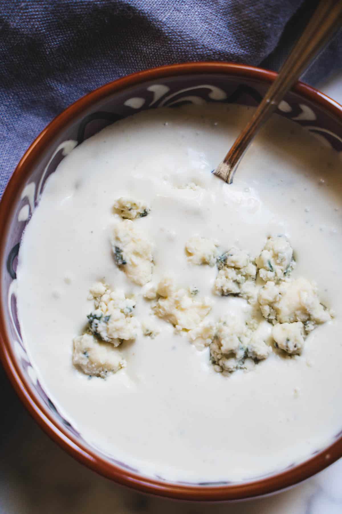 Blue cheese sauce in a small bowl for buffalo chicken hummus bowl.