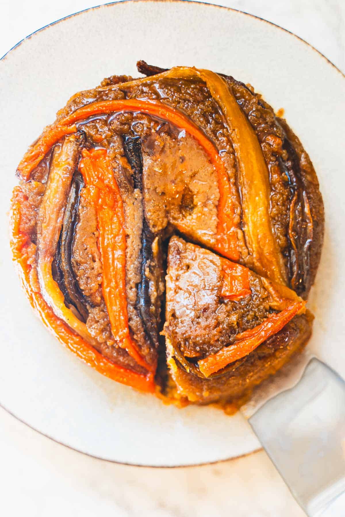 Carrot upside down cake flipped out of pan onto blue plate.
