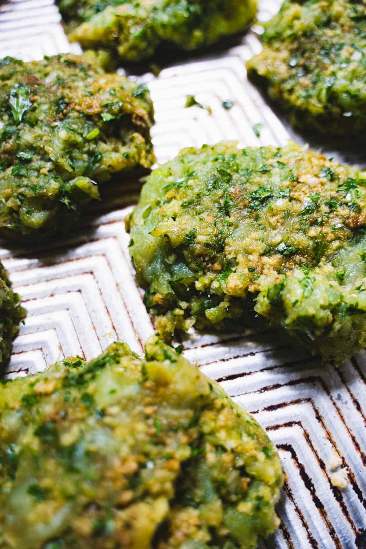 Cod mixture shaped into cod cakes on a baking sheet.