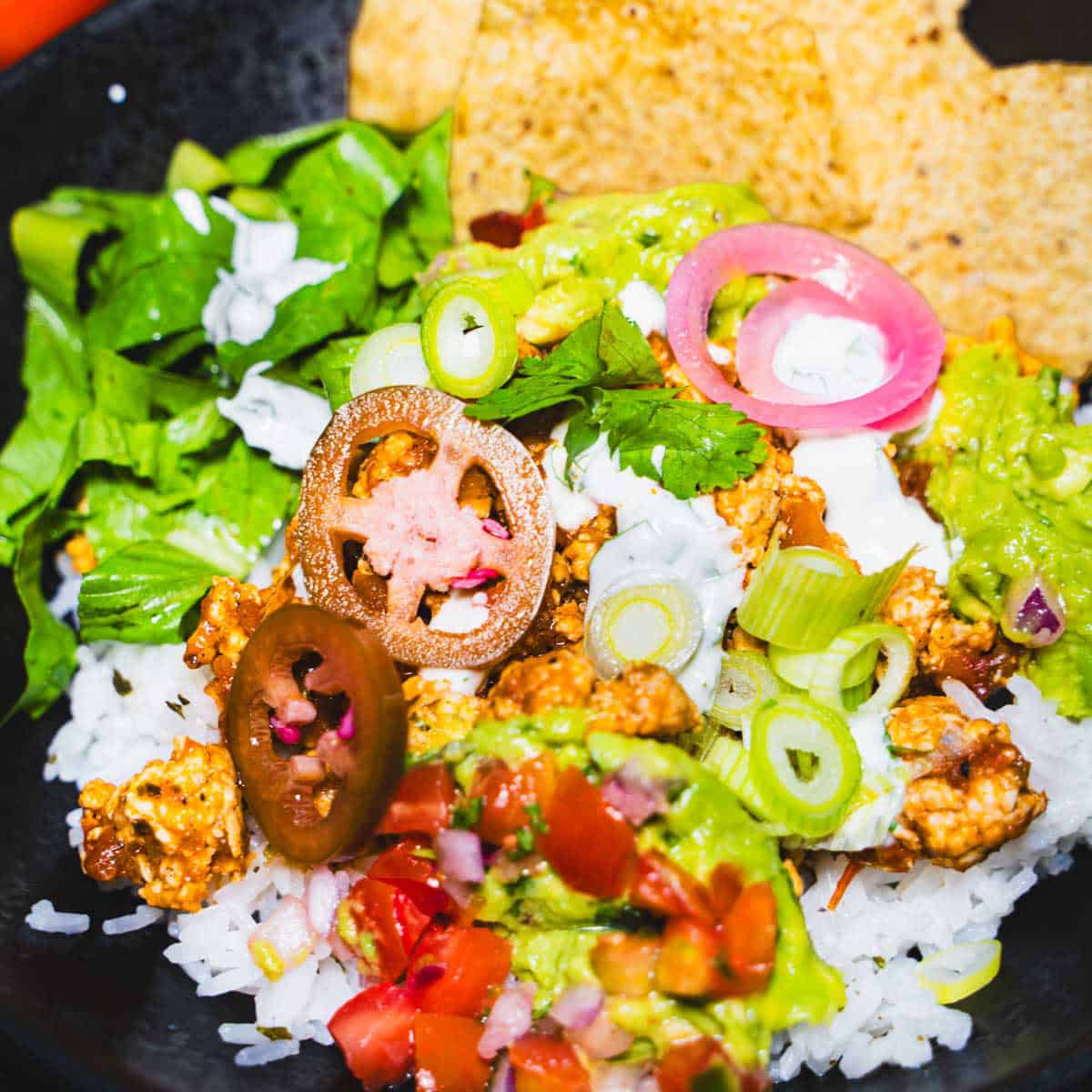 Salsa Verde Chicken Rice Bowl assembled in a black bowl.