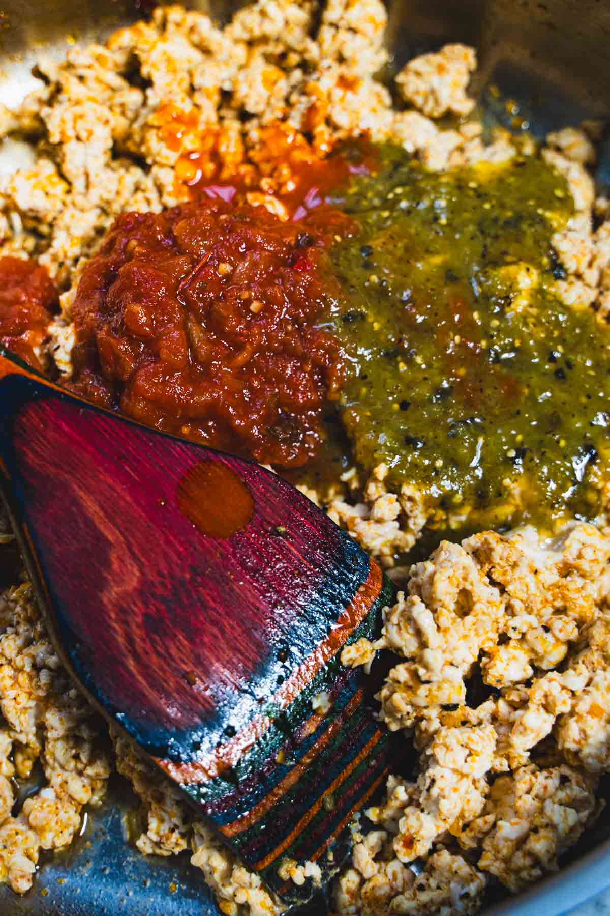 Salsa verde and red salsa and ot sauce poured over seasoned ground chicken for salsa verde chicken rice bowls.