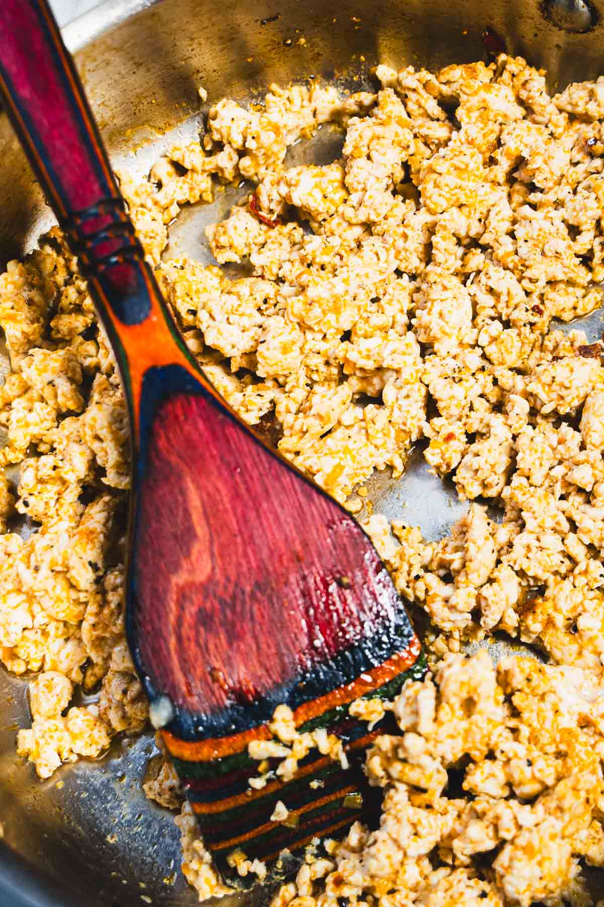 Browned ground chicken with taco seasoning in a skillet.